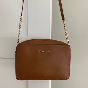 Michael Kors crossbody bag with adjustable strap.